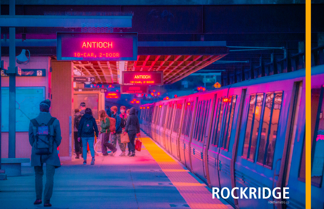 A photo poster that says Rockridge, with a vertical yellow line overlaid. It shows the Rockridge platform at night, with cartoonishly bold colors. It is an open air platform with a partially sheltered station exit to the left of the image, and a legacy BART train to the right. The station concrete and metal is a cool blue, as it is the highway visible beyond the platform. There is bright red light from the overhead signs. There is a group of people walking towards the station exit, which is lit with warm lighting. The train is lit a mixture of blue purple and red.